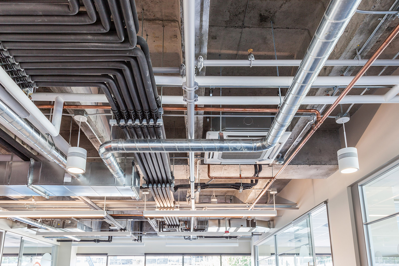 network of industrial pipes on ceiling